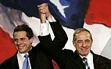 In this November 7, 2006 file photo, then New York Attorney General Elect Andrew Cuomo (L) joins hands with his father, former New York Governor Mario Cuomo (R), during a rally held by New York Democrats in New York.  (photo credit: AFP PHOTO / Files / Timothy A. CLARY)