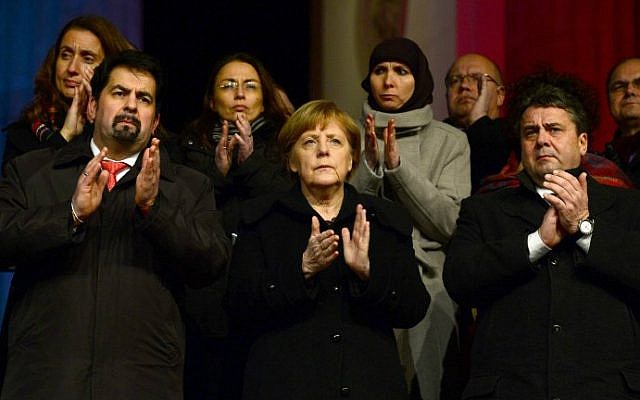 German Chancellor Angela Merkel (center) applauds during a Muslim community tolerance rally on January 13, 2015 in Berlin (photo credit: AFP/JOHN MACDOUGALL) German Chancellor Angela Merkel (center) applauds during a Muslim community tolerance rally on January 13, 2015 in Berlin (photo credit: AFP/JOHN MACDOUGALL)