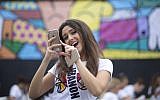 FILE - In this Sunday, Jan. 11, 2015 file photo, Miss Lebanon, Saly Greige, poses for photos after she painted on a wall in Miami's Wynwood area. (photo credit: AP Photo/J Pat Carter, File)