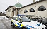 Illustrative: a police car stands in front of a mosque in Uppsala, Sweden, after a burnt-out Molotov cocktail was found early on January 1, 2015. (AFP/TT News Agency/Pontus Lundahl)