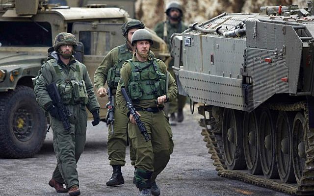 Israeli army soldiers in the Mount Dov region on January 28, 2015, shortly after two soldiers were killed and seven others were wounded in a Hezbollah attack (photo credit: AP Photo/ Ariel Schalit)