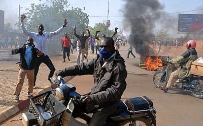 Smoke billows in a street as people demonstrate against French weekly Charlie Hebdo's publication of a cartoon of the Prophet Muhammad near the grand mosque in Niamey, Niger on January 17, 2015. (photo credit: AFP/Boureima Hama)