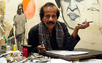 In this photograph taken on January 9, 2015, Pakistani cartoonist Rafique Ahmad, alias "FEICA" draws at his office in Karachi. In the face of Pakistan's prolific use of blasphemy laws and a culture of political violence, cartoonists must tread a thin line (photo credit: AFP / Asif Hassan)