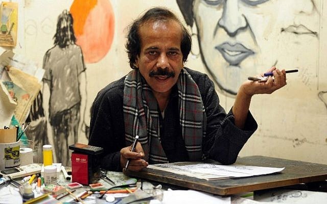 In this photograph taken on January 9, 2015, Pakistani cartoonist Rafique Ahmad, alias "FEICA" draws at his office in Karachi. In the face of Pakistan's prolific use of blasphemy laws and a culture of political violence, cartoonists must tread a thin line (photo credit: AFP / Asif Hassan) In this photograph taken on January 9, 2015, Pakistani cartoonist Rafique Ahmad, alias "FEICA" draws at his office in Karachi. In the face of Pakistan's prolific use of blasphemy laws and a culture of political violence, cartoonists must tread a thin line (photo credit: AFP / Asif Hassan)