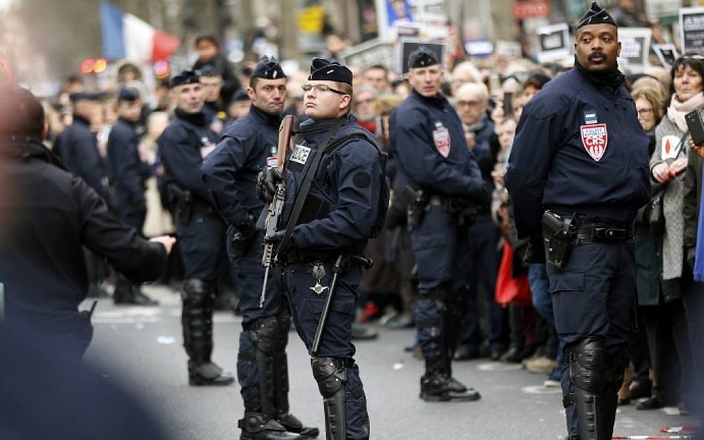 French riot police keep watch during a unity rally  in Paris on January 11, 2015 held in tribute to the 17 victims of the three-day killing spree (photo credit: AFP/ THOMAS SAMSON)