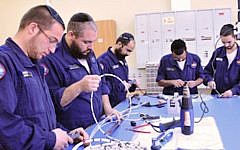 Members of the Shahar program work on a tech project (Courtesy: IAF)
