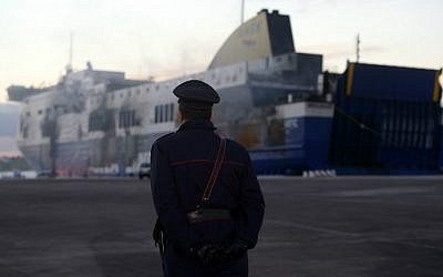An Italian Carabiniere patrols during the checking of the Italian-owned Norman Atlantic ferry moored at the pier at the port of Brindisi on January 2, 2015 (photo credit: AFP/ Filippo Monteforte) 