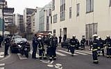 Police officers and firefighters gather in front of the offices of the French satirical newspaper Charlie Hebdo in Paris on January 7, 2015, after armed gunmen stormed the offices leaving 11 dead. (AFP/Philippe Dupeyrat)
