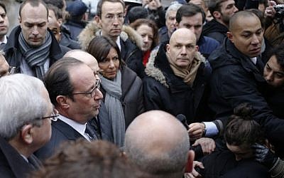 French President Francois Hollande (C) speaks to the press after arriving at the headquarters of the French satirical newspaper Charlie Hebdo in Paris on January 7, 2015, after armed gunmen stormed the offices leaving eleven dead. (Photo credit: AFP/ KENZO TRIBOUILLARD) French President Francois Hollande (C) speaks to the press after arriving at the headquarters of the French satirical newspaper Charlie Hebdo in Paris on January 7, 2015, after armed gunmen stormed the offices leaving eleven dead. (Photo credit: AFP/ KENZO TRIBOUILLARD)
