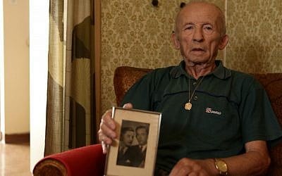 Stefan Weiss, with a photograph of his family, in his room at Reuth. (photo credit: Eldad Rafaeli)