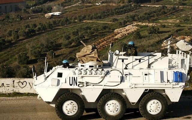 A Spanish UNIFIL peacekeeper drives an armored vehicle in the Lebanese town of Adaisseh, near the border with Israel, on January 19, 2015. (AFP/Mahmoud Zayyat)