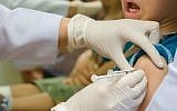 Illustrative: A child receives a vaccination shot (Shutterstock/JTA)
