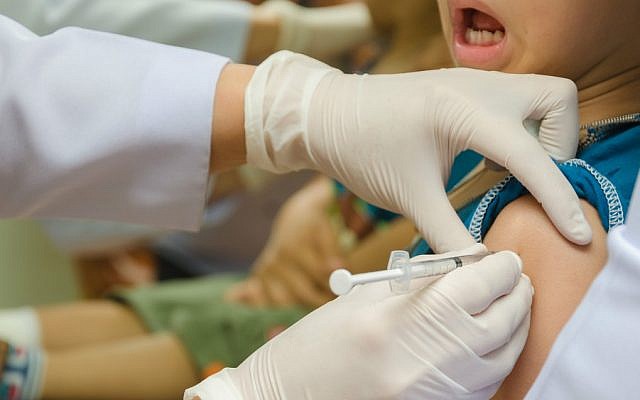 Illustrative: A child receives a vaccination shot (Shutterstock/JTA)