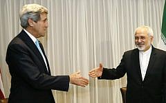 Iranian Foreign Minister Mohammad Javad Zarif shakes hands with US State Secretary John Kerry in Geneva, Jan. 2015 (photo credit: AFP / POOL / RICK WILKING)
