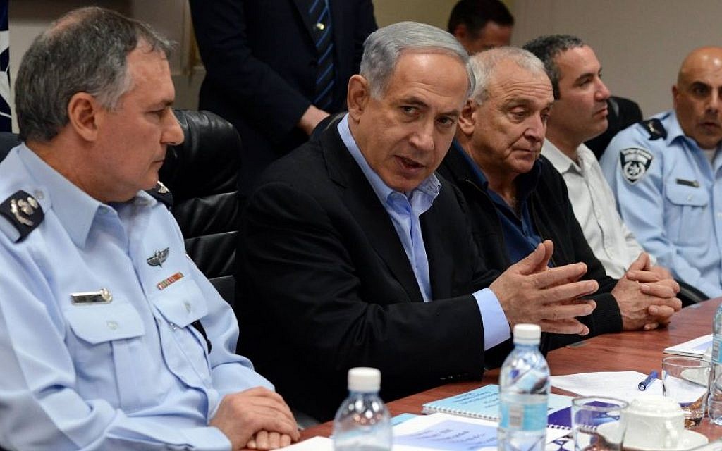 Prime Minister Benjamin Netanyahu heading a meeting on preparedness for the storm that is expected to hit Israel on the weekend, on February 19, 2015. On his left is chief of police Comm. Yochanan Danino and on his right is Public Security Minister Yitzhak Aharonovitch. (photo credit: Haim Tzach/GPO)