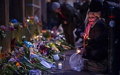 Well-wishers bring flowers and light candles to honor the shooting victims outside the main Synagogue in Copenhagen, Denmark on February 15, 2015. (AFP/Odd Andersen)