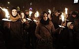 People hold candles during a memorial service for those killed by a gunman in Copenhagen, February 16, 2015 (Photo credit: Bax Lindhardt/Scanpix Denmark/AFP)