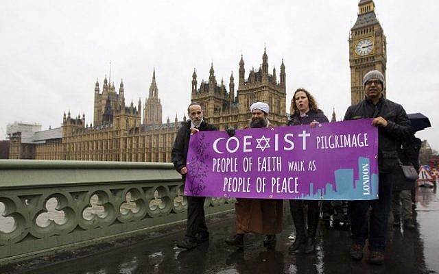 (From left to right) Rabbi Jonathan Wittenberg, the Assistant Secretary General of the Muslim Association of Great Britain, Ibrahim Mogra, Reverend Margaret Cave and unidentified person carry a banner reading 'Coexist pilgrimage - people of faith walk as people of peace' at an inter-religious march for peace in London on February 19, 2015. (photo credit: Justin Tallis/AFP) (From left to right) Rabbi Jonathan Wittenberg, the Assistant Secretary General of the Muslim Association of Great Britain, Ibrahim Mogra, Reverend Margaret Cave and unidentified person carry a banner reading 'Coexist pilgrimage - people of faith walk as people of peace' at an inter-religious march for peace in London on February 19, 2015. (photo credit: Justin Tallis/AFP)