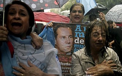 People take part under heavy rain in the March of Silence called by Argentine prosecutors in memory of their late colleague Alberto Nisman in Buenos Aires on February 18, 2015. (photo credit: AFP/Juan Mabromata)
