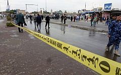 Police tape is hung near the site where a suicide bomber detonated explosives inside a restaurant in Baghdad al-Jadida, east of the capital, on February 7, 2015 (Photo credit: Sabah Arar/AFP)