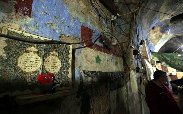 Syrian national Jihad al-Mohamed stands in an abandoned synagogue where has has been living in Lebanon's southern city of Sidon on Feb. 8, 2015. Five destitute Syrian and Palestinian families have taken up residence in the synagogue and few signs remain to indicate that the building was once a Jewish house of worship. (Photo credit: Joseph Eid/AFP) Syrian national Jihad al-Mohamed stands in an abandoned synagogue where has has been living in Lebanon's southern city of Sidon on Feb. 8, 2015. Five destitute Syrian and Palestinian families have taken up residence in the synagogue and few signs remain to indicate that the building was once a Jewish house of worship. (Photo credit: Joseph Eid/AFP)