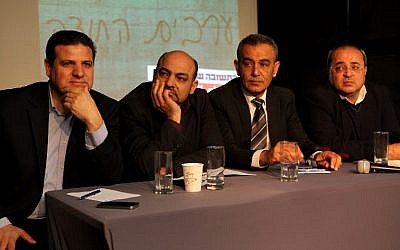Joint Arab List members (from left to right), Ayman Odeh, Masud Ghanayem, Jamal Zahalka and Ahmad Tibi sit together during a press conference in Tel Aviv on February 11, 2015. (photo credit: AFP/GIL COHEN-MAGEN)