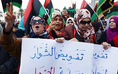 Libyan supporters of 'Fajr Libya' (Libya Dawn), a mainly Islamist alliance, take part in a protest in Tripoli's central Martyr's Square on February 20, 2015, against recent Egyptian air strikes on the Islamic State group's bases in eastern Libya. (AFP Photo/Mahmud Turkia)