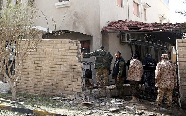 Libyan security forces inspect the site of a bomb explosion at the entrance of the residence of the Iranian ambassador in the capital Tripoli on February 22, 2015. (Photo credit: AFP/STR) Libyan security forces inspect the site of a bomb explosion at the entrance of the residence of the Iranian ambassador in the capital Tripoli on February 22, 2015. (Photo credit: AFP/STR)