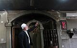 Palestinian Imam Ibrahim Abu Luha shows the damage at a mosque that was torched overnight in the West Bank village of al-Jaba, southwest of Bethlehem, February 25, 2015. (photo credit: AFP/MUSA AL-SHAER)