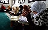 Mourshidates, female religious guides appointed by the Algerian religious affairs ministry to spread the good word of Islam and a message of tolerance, read the Koran, Islam's holy book, at the Ennidal mosque in the Algerian capital, Algiers, on February 22, 2015. (Photo credit: AFP/ FAROUK BATICHE)