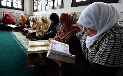 Mourshidates, female religious guides appointed by the Algerian religious affairs ministry to spread the good word of Islam and a message of tolerance, read the Koran, Islam's holy book, at the Ennidal mosque in the Algerian capital, Algiers, on February 22, 2015. (Photo credit: AFP/ FAROUK BATICHE)
