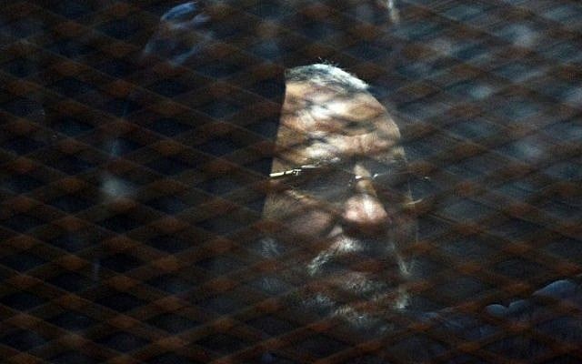 Egyptian Muslim Brotherhood leader Mohammed Badie stands behind bars during his trial in Cairo on February 28, 2015 (Mohamed el-Shahed) Egyptian Muslim Brotherhood leader Mohammed Badie stands behind bars during his trial in Cairo on February 28, 2015 (Mohamed el-Shahed)