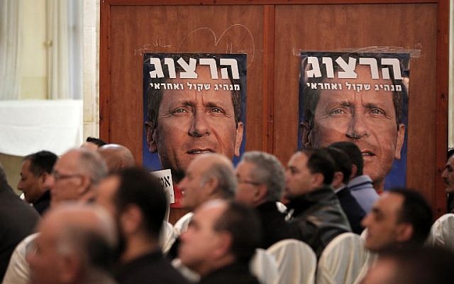 Israeli Arabs sit under a poster of Isaac Herzog, leader of the Zionist Union party, during an election campaign press conference in the northern Israeli-Arab town of Shfaram on February 28, 2015 (AFP PHOTO/AHMAD GHARABLI) Israeli Arabs sit under a poster of Isaac Herzog, leader of the Zionist Union party, during an election campaign press conference in the northern Israeli-Arab town of Shfaram on February 28, 2015 (AFP PHOTO/AHMAD GHARABLI)