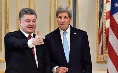 Ukrainian President Petro Poreshenko (L) welcomes US Secretary of State John Kerry (R) during a bilateral meeting in Kiev, on February 5, 2015. Kerry flew in to Kiev where Ukraine's pro-Western leaders hope Washington will send in weapons for their battle against pro-Russian separatists. (photo credit: Sergei Supinsky/AFP) 
