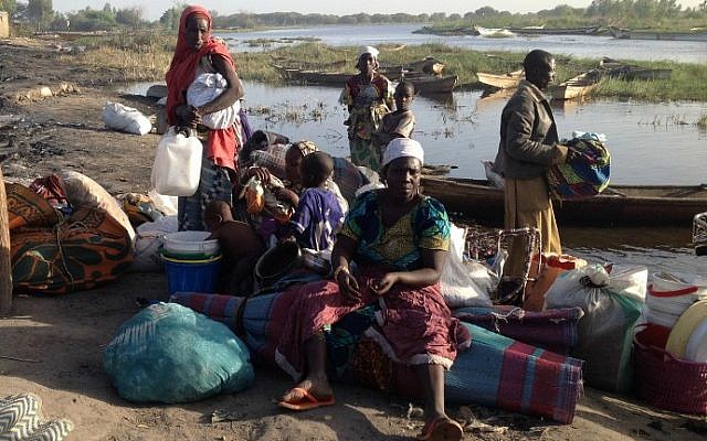 Members of a family gather their belongings as they wait to flee Nougboua after Nigeria's Boko Haram rebels carried out an attack on the village on February 13, 2015. (photo credit: AFP/Stephanie Yas)