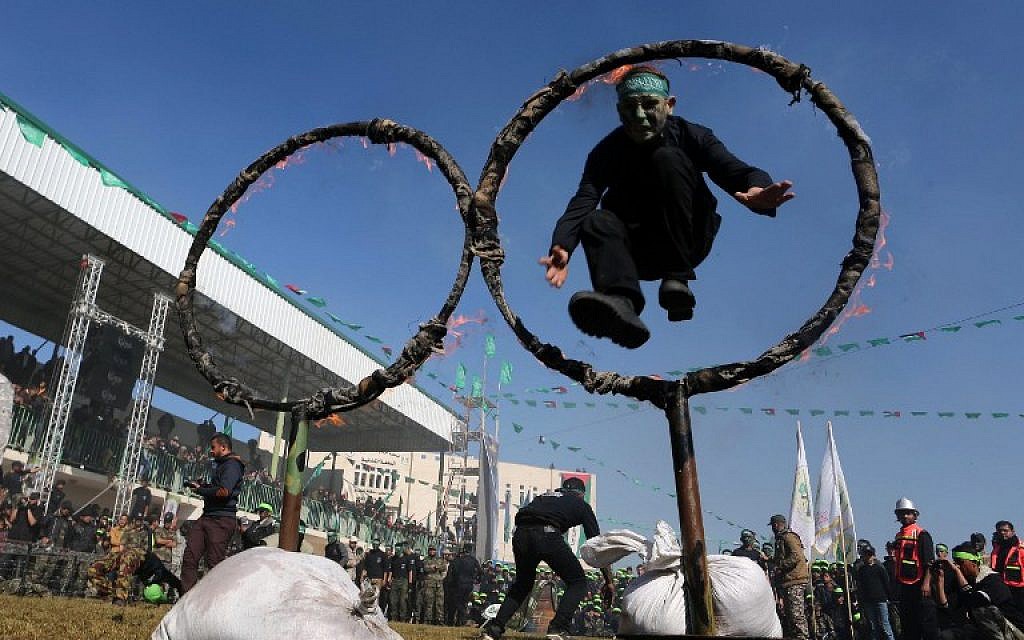 A file picture taken on January 29, 2015, shows Palestinian youth showing their skills during a graduation ceremony for a training camp run by the Hamas movement in Khan Yunis, in the southern Gaza Strip. (photo credit:  AFP PHOTO / SAID KHATIB)