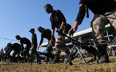 A file picture taken on January 29, 2015, shows Palestinian youth showing their skills during a graduation ceremony as part of a training camp run by the Hamas movement in Khan Yunis, in the southern Gaza Strip. (AFP photo/Said Khatib)