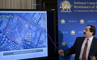 Alireza Jafarzadeh, Deputy Director of the Washington office of the National Council of Resistance of Iran, shows satellite photos of an alleged secret Iranian nuclear facility during a press conference at the National Press Club in Washington, DC, February 24, 2015. (photo credit: AFP/BRENDAN SMIALOWSKI)
