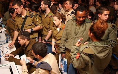 Lone Soldiers handle personal affairs during a special event sponsored by Nefesh B'Nefesh, Friends of the IDF and Israeli government ministries. (photo credit: Courtesy Yonit Schiller / Nefesh B'Nefesh