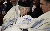 Illustrative: Abraham Romi Cohn performs the 'metzitzah b'peh'  ritual at a circumcision in New York, February 11, 2015. (AP/Seth Wenig)
