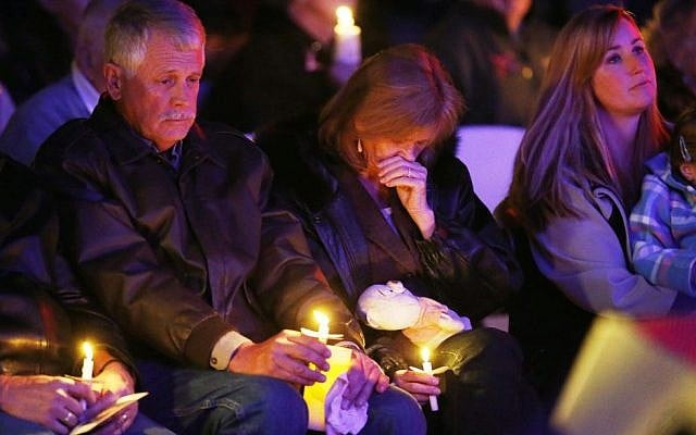 Carl, left, and Marsha Mueller, center, hold candles at the memorial in honor of their daughter Kayla Mueller on Wednesday, Feb. 18, 2015, in Prescott, Ariz. (Photo credit: AP/The Arizona Republic, Rob Schumacher) Carl, left, and Marsha Mueller, center, hold candles at the memorial in honor of their daughter Kayla Mueller on Wednesday, Feb. 18, 2015, in Prescott, Ariz. (Photo credit: AP/The Arizona Republic, Rob Schumacher)