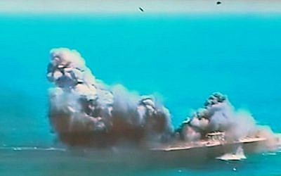 This image taken from Iranian state TV, shows footage of damage to a mock US aircraft carrier during large-scale naval and air defense drills by Iran's Revolutionary Guard, near the Strait of Hormuz, Iran, Wednesday, Feb. 25, 2015. The drill, named Great Prophet 9, was the first to involve a replica of a US carrier. (photo credit: AP Photo/Iran TV)