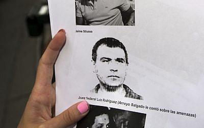 A reporter holds a picture of Antonio 'Jaime' Stiusso, one of the country's most enigmatic spy chiefs, outside the prosecutor's office in Buenos Aires, Argentina, on February 5, 2015. (photo credit: AP/Rodrigo Abd)
