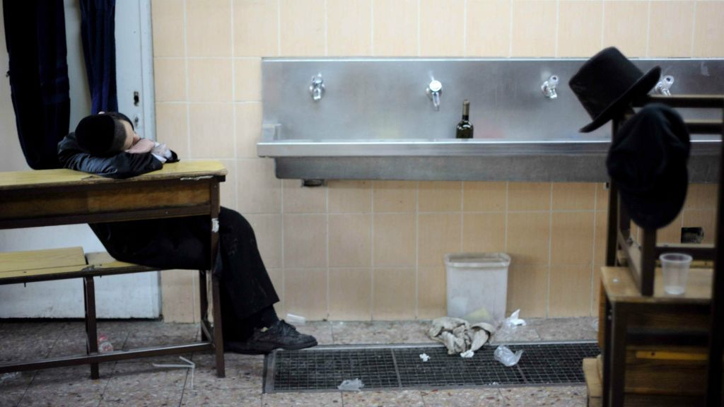 This photograph of a young boy seated amidst the aftermath of a Purim celebration is one of Yaari's favorite in the series (photo credit: Gili Yaari)