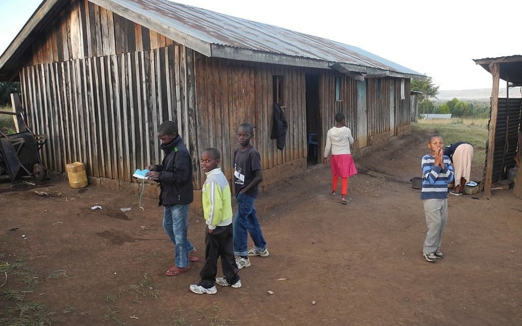 The homes in Kasuku are made of rough wooden slats and do not have electricity or running water. (Melanie Lidman/Times of Israel)