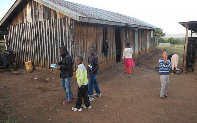 The homes in Kasuku are made of rough wooden slats and do not have electricity or running water. (Melanie Lidman/Times of Israel)