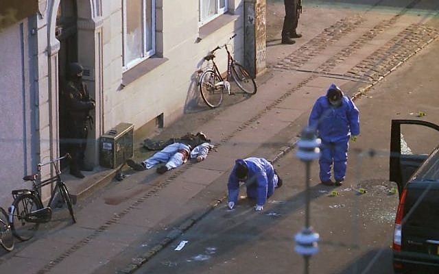 In this image made from TV the lifeless body of a shooting suspect lays on the pavement as Danish police forensic officers examine the scene after Danish police shot and killed the man early Sunday  February 15, 2015. (photo credit: AP/TV2 Norway) 