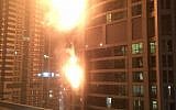 Flames coming from a high rise tower in Dubai's marina district Saturday, Feb. 21, 2015. The fire broke out early Saturday in the Torch tower on the northeastern end of the densely populated district, which is packed with multi-story skyscrapers. Debris from the fire cluttered nearby streets after the blaze appeared to be extinguished. (photo credit: AP Photo/Rhea Saran)