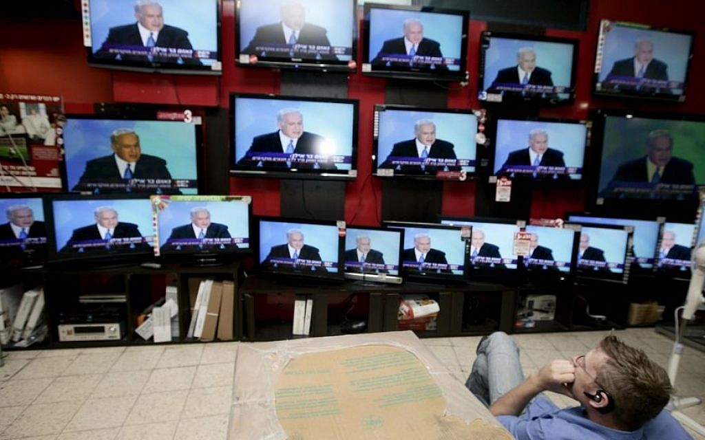 A shopper stands in front of televisions broadcasting a speech by Prime Minister Benjamin Netanyahu at an electronics shop in Jerusalem. (Abir Sultan/Flash90) A shopper stands in front of televisions broadcasting a speech by Prime Minister Benjamin Netanyahu at an electronics shop in Jerusalem. (Abir Sultan/Flash90)