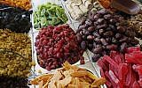 Overflowing containers of dried fruits -- from near and far -- at Jerusalem's Mahane Yehuda market (photo credit: Miriam Alster/Flash 90)